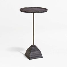 a small table with a black marble top and metal base on an isolated white background