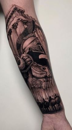 a man's arm with a black and grey tattoo design on the left forearm