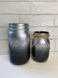 two mason jars are sitting next to each other