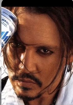 a close up of a person with a bottle of water on his head and hair