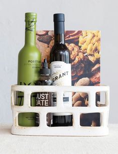 an assortment of food and drink items in a white container on top of a table