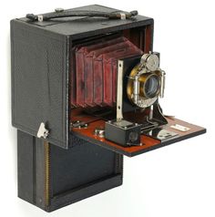 an old fashioned camera sitting on top of a table