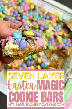 someone is holding up a cookie bar with easter eggs on it and the words seven layer easter magic cookie bars