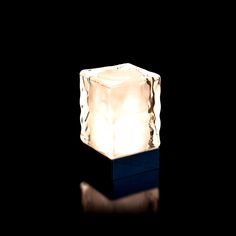 a light that is sitting on top of a block of ice in the middle of the night