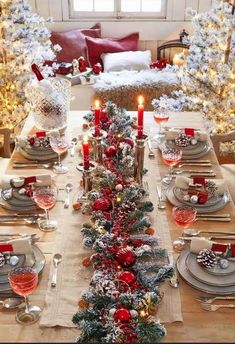 a christmas table setting with candles and decorations