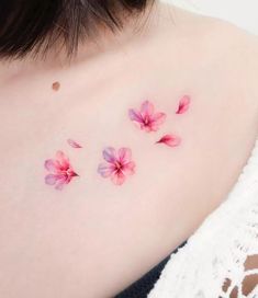 pink flowers on the back of a woman's shoulder