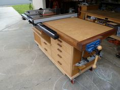 a workbench with drawers and tools on it