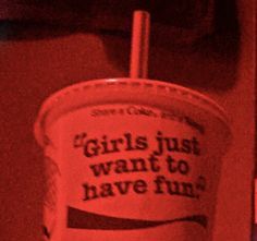 a red cup with the words girls just want to have fun on it and a straw