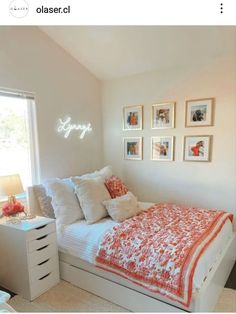 a bedroom with white walls and pictures on the wall above the bed that says simply