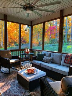 a screened porch with chairs and tables on it