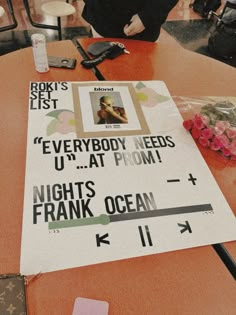 there is a sign on the table that says everybody needs u - at prom nights frank ocean