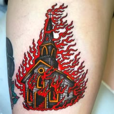 a tattoo with a church and flames on it