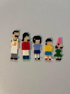 five lego people are standing in a row