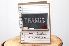 a teacher's day card sitting on top of a tree stump with the words thanks written on it