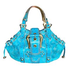 A stunning turquoise & gold suede and ostrich skin bag by Louis Vuitton Designed by Marc Jacobs This bag was produced in a very limited edition and made to order Finest suede leather imprinted with the famous LV monogram logo Golden hardware Edges & corners carefully hand-painted in gold color Ostrich skin trimming Lined with champagne-colored satin fabric Made in France Retailed for circa 8995$ plus taxes Please refer to the AD and editorial pictures for size / season reference only. All pictur Editorial Pictures, 2000s Fashion Icons, Fancy Purses, Louis Vuitton Limited Edition, Lv Monogram, Bags Logo, Monogram Logo, Beautiful Bags, Dream Wardrobe