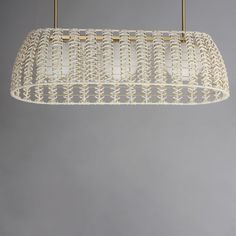 a white woven light fixture hanging from a ceiling