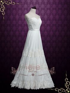 a white wedding dress is on display in front of a purple wall with gold trimmings