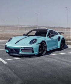 a blue porsche sports car parked in a parking lot