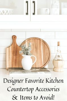 a wooden cutting board sitting on top of a counter next to a vase with flowers