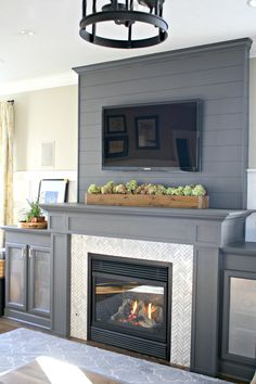 a living room with a fireplace and tv above it