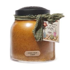 a jar filled with honey on top of a white table next to a tag that says honey flask cider