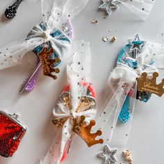 several different types of hair clips on a white surface with confetti scattered around them