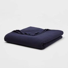 a folded blue blanket on a white background