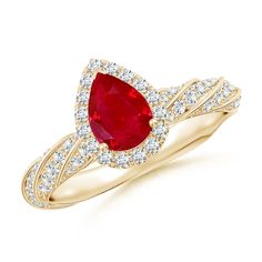 a yellow gold ring with a pear shaped ruby and diamonds