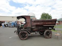 an old truck is parked in a parking lot