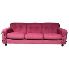 a pink couch sitting on top of a white floor