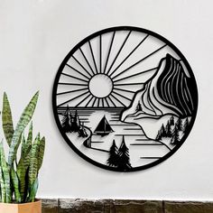 a metal wall art with mountains and trees on it