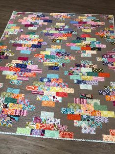 a patchwork quilt is laying on the floor