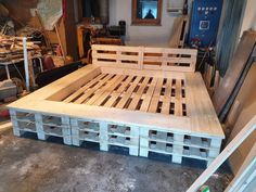 a bed made out of wooden pallets in a room