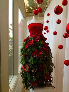 a mannequin dressed in red and green christmas decorations