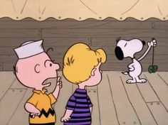 a cartoon character is talking to a little boy with a dog in front of him