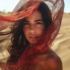 a woman with freckles on her head and veil over her face in the desert