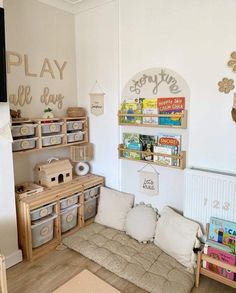 a child's play room with toys and bookshelves on the wall,