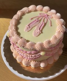 a pink and white cake on a plate