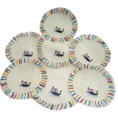 five paper plates with boats on them