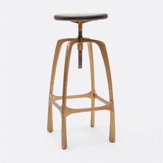 the stool is made from wood and has a wooden seat with an adjustable footrest