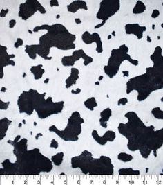 a black and white cow print fabric with an area for the ruler to be displayed