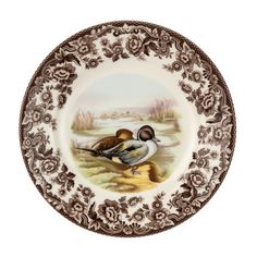 a brown and white plate with two birds on it