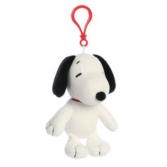 a white and black stuffed dog with a red leash