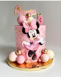 a pink and gold minnie mouse birthday cake