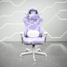 a purple and white chair with an animal print on the back, sitting in front of a wall