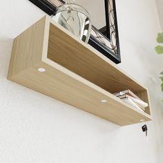 a wooden shelf with a mirror above it