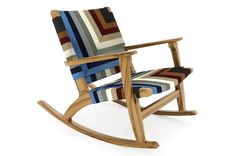 a wooden rocking chair with multicolored stripes on it