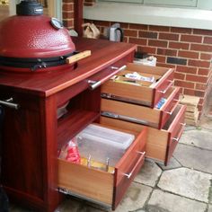 an outdoor bbq with drawers on the outside