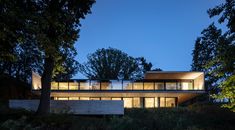 the house is surrounded by trees at night