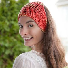 a woman wearing a red knitted headband